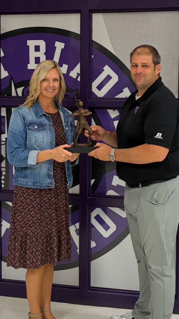 Mrs Bryant receives a knight tropy from Mr Orrock