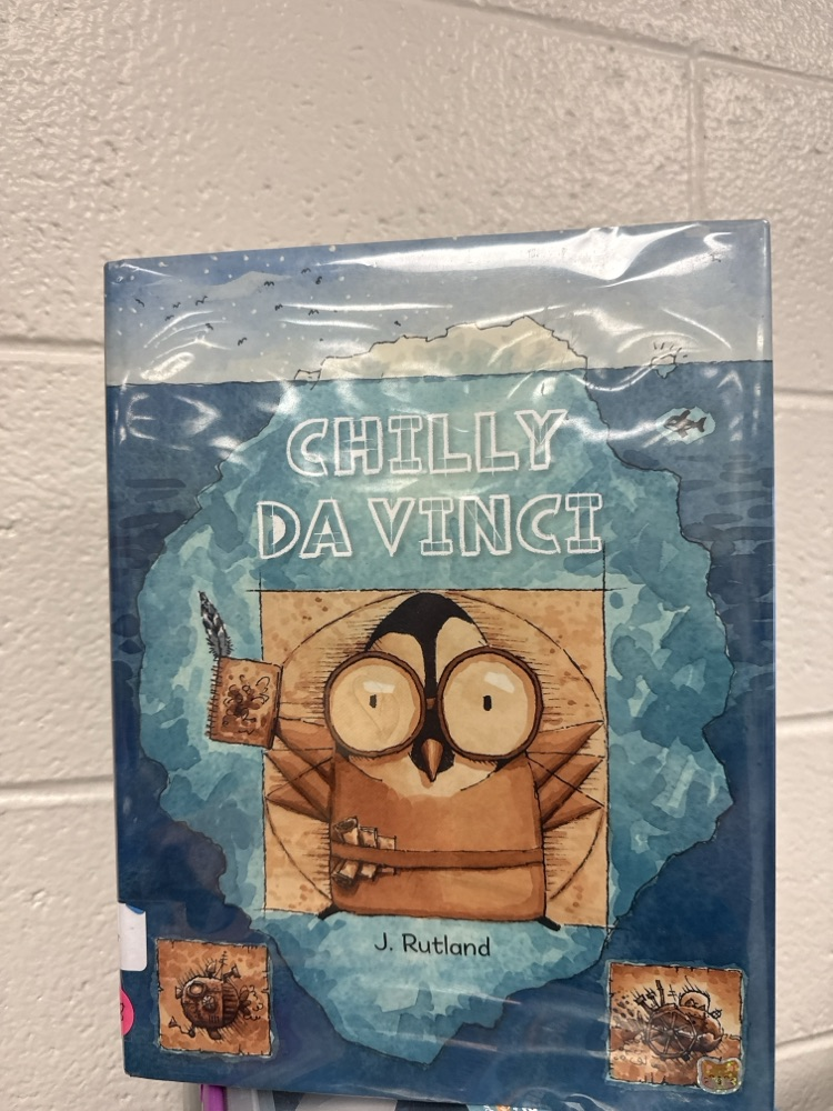 Book titled Chilly Da Vinci by J. Rutland featuring an illustrated penguin styled like Leonardo da Vinci on a blue background.