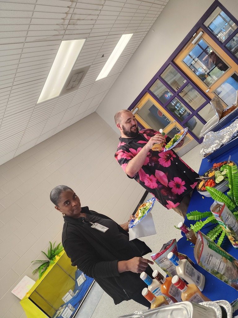 Two staff memberes making plates at the buffet table