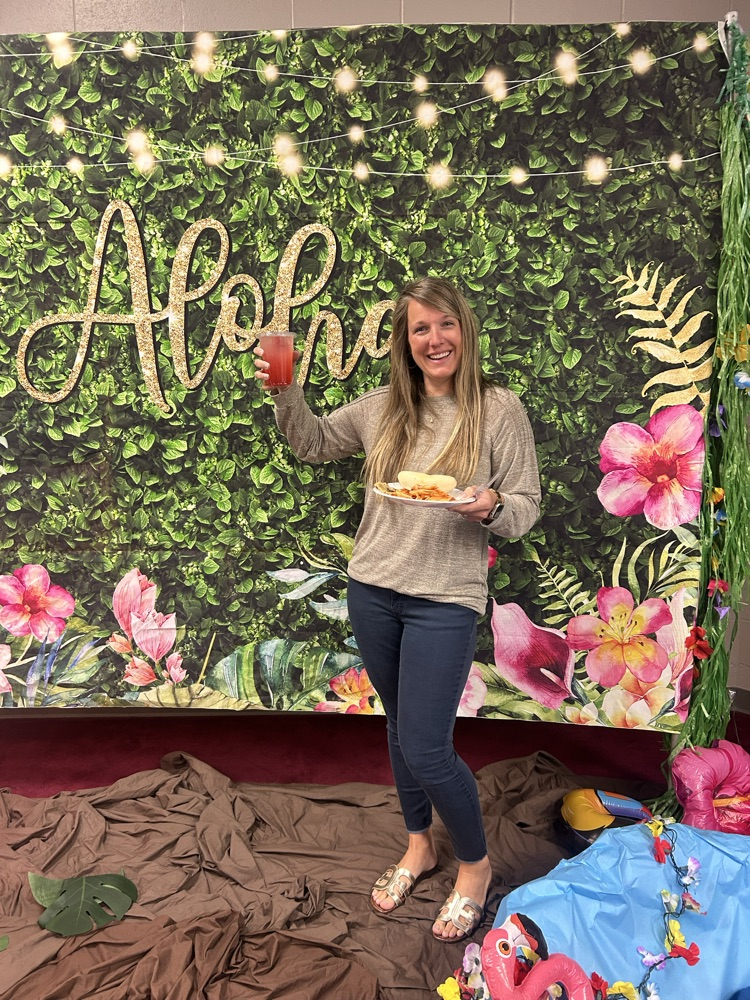 posing with their dirty sodas in front of the aloha Hawaiian backdrop