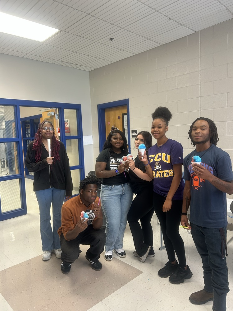 6 students posing with their snowcones and college shirts to show off their post secondary choices