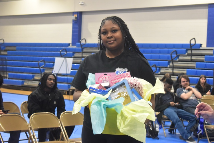 young woman posing with her basket that she won as a prize during the decision day