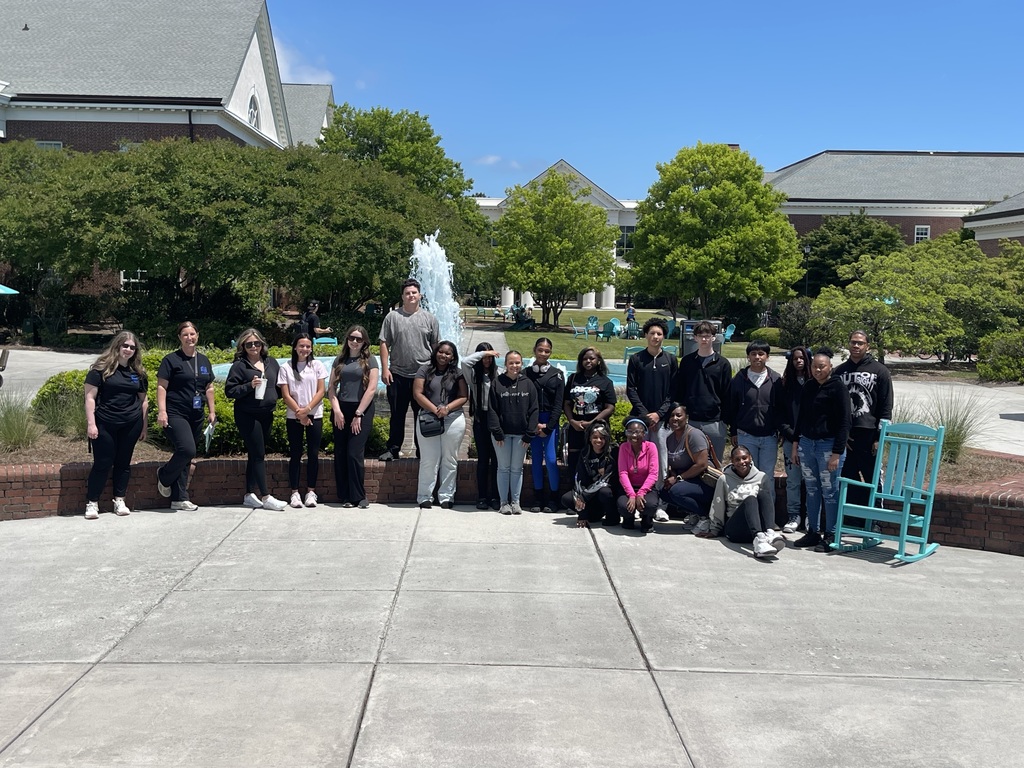 Students in front of a waterfall visiting UNCW.
