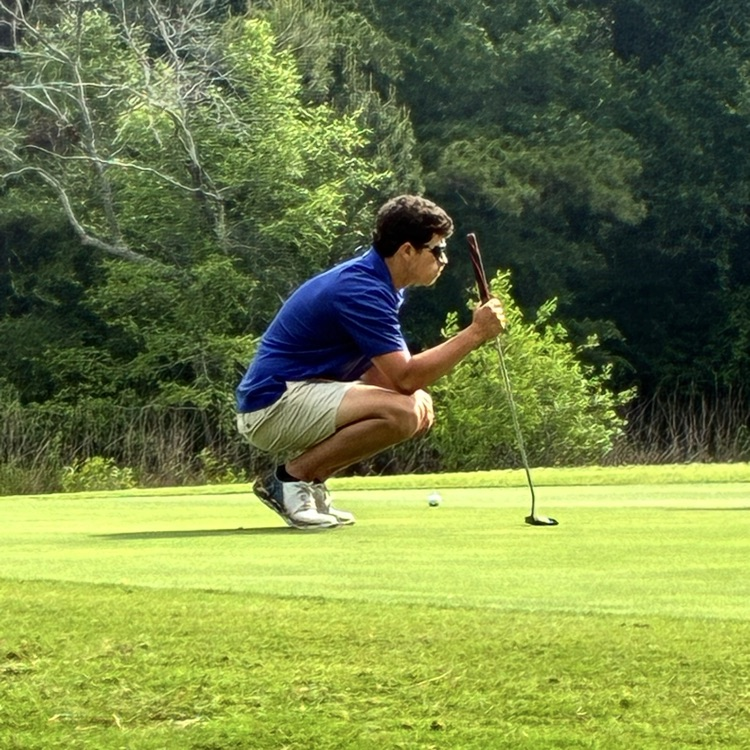 Henry Simmons works on putting practice on the golf course  