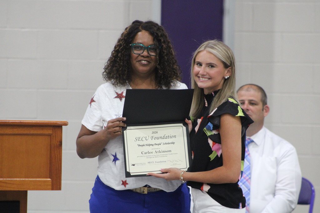 A student smiles while receiving the SECU Foundation “People Helping People” Scholarship during West Bladen High School’s Scholastic Awards and Scholarship Night.