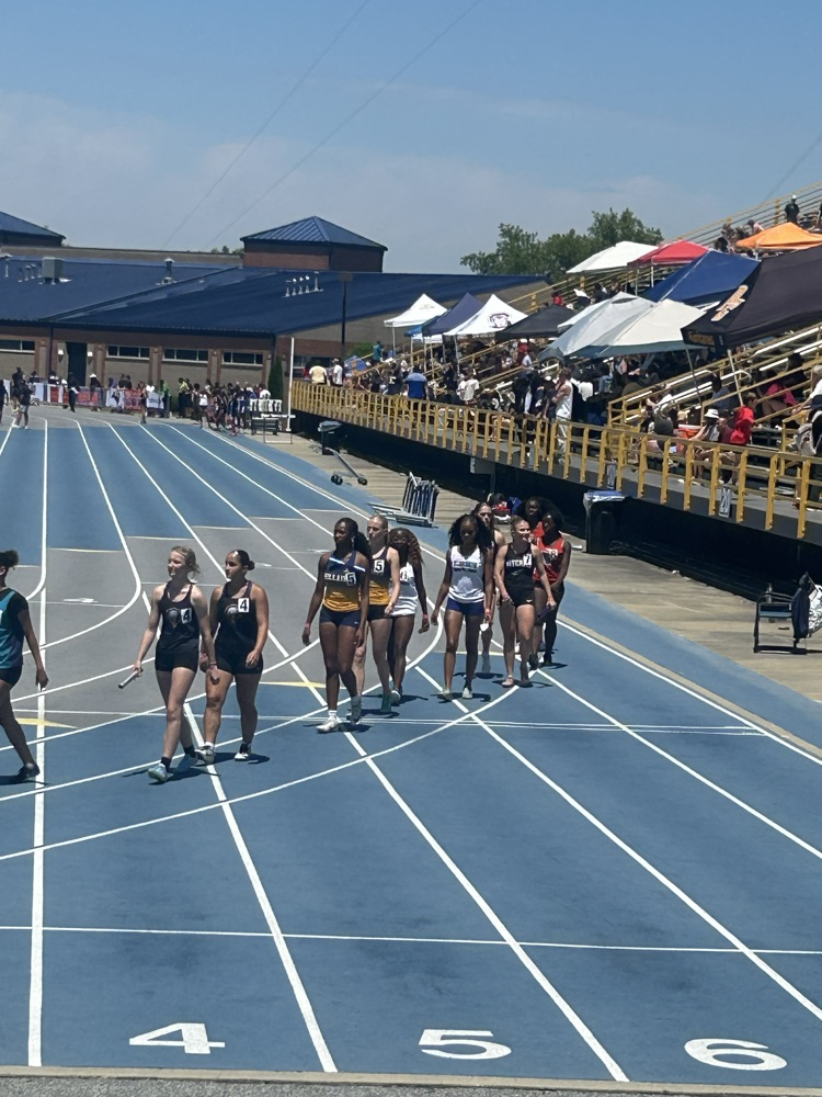 students walking on a track preparing for a meet