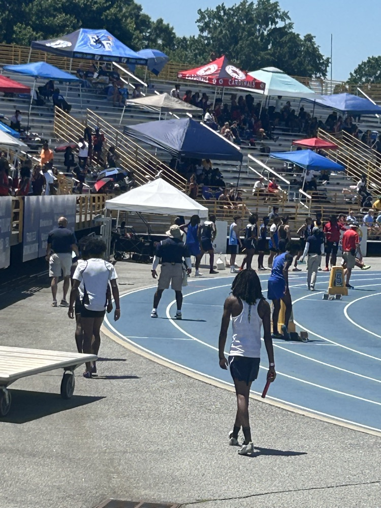 students walking on a track preparing for a meet