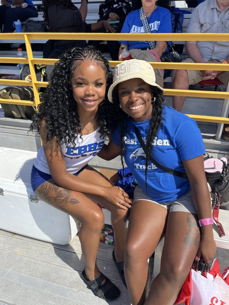 track athlete hugging a coach wearing a blue tshirt
