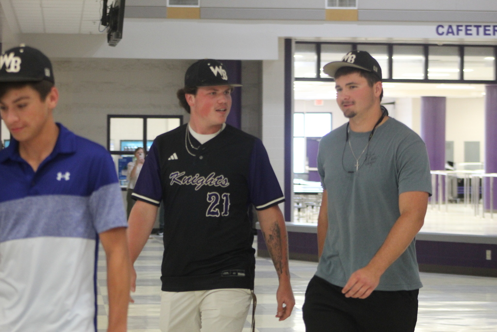 Two West Bladen varsity baseball players walk through the school atrium during the team’s playoff send-off ahead of their matchup against Whiteville in the NCHSAA playoffs.