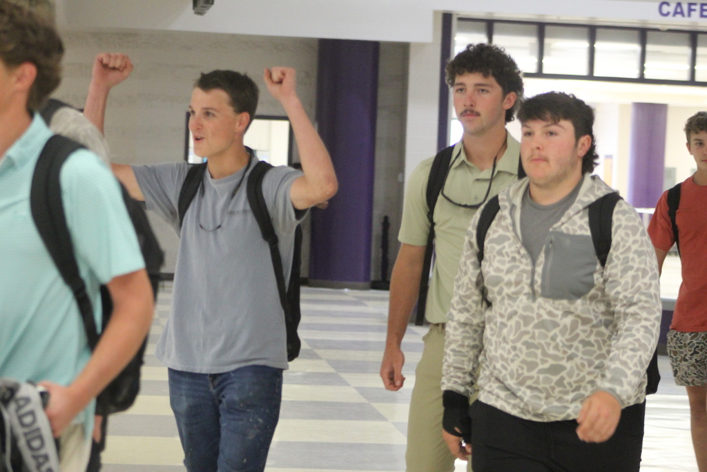 West Bladen varsity baseball players walk through the school atrium during their playoff send-off as classmates and staff cheer them on before the Whiteville game.