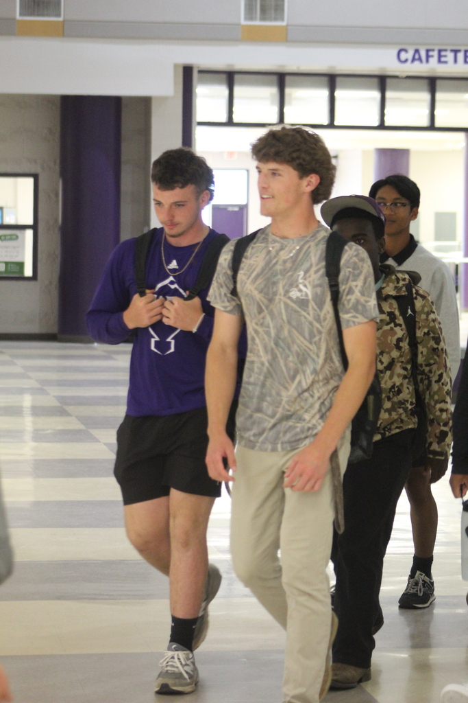Members of the West Bladen varsity baseball team walk through the school atrium during a playoff send-off before traveling to face Whiteville in the third round of the NCHSAA playoffs.