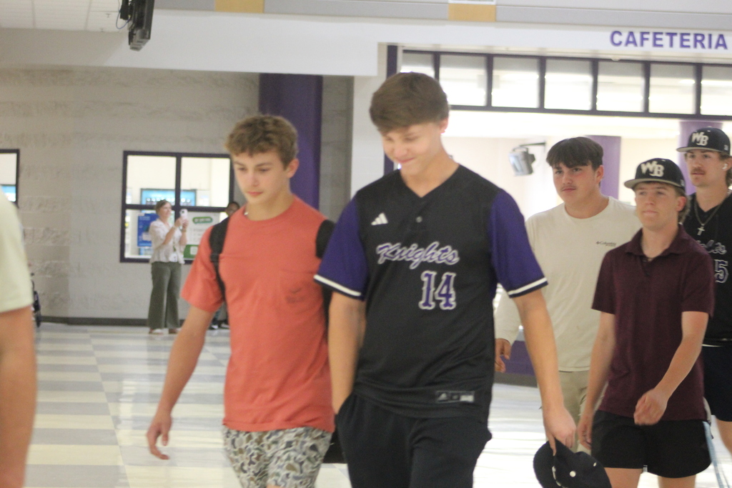 West Bladen varsity baseball players make their way through the school atrium during a send-off before competing against Whiteville in the third round of the state playoffs.