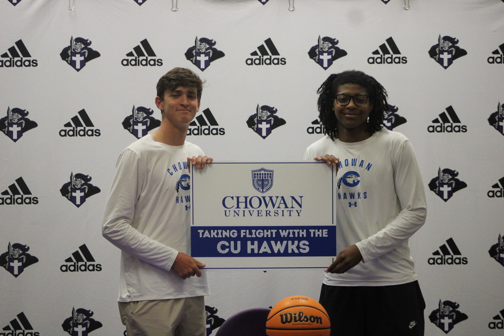 Jackson Pait and Tylik McCall hold a Chowan University sign after officially signing to continue their basketball careers with the CU Hawks.