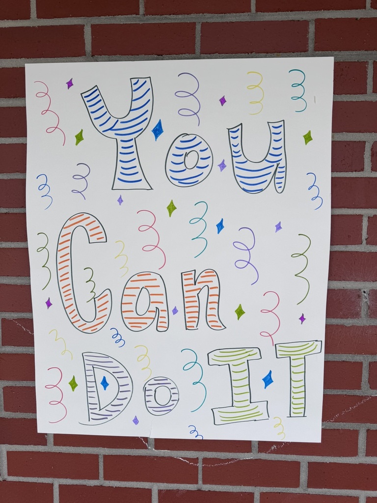 Posters featured bright drawings, popcorn buckets, pizza slices, gumball machines, and motivational phrases like “You are READY!” and “You got this!” displayed along the brick hallway walls.
