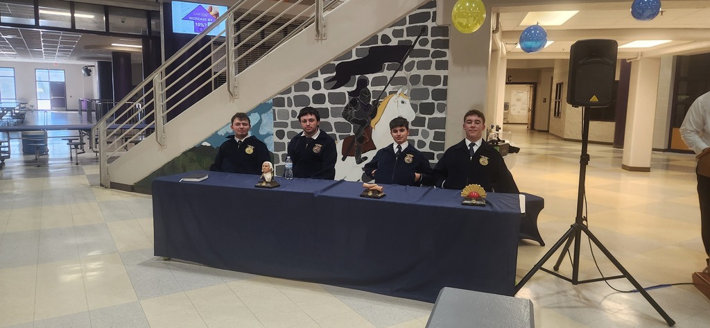 A row of West Bladen FFA student officers in official dress sitting at the head table during the chapter banquet