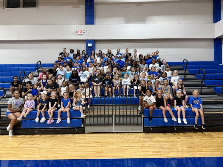 large group of young girls sitting on bleachers for cheer camp at East Bladen