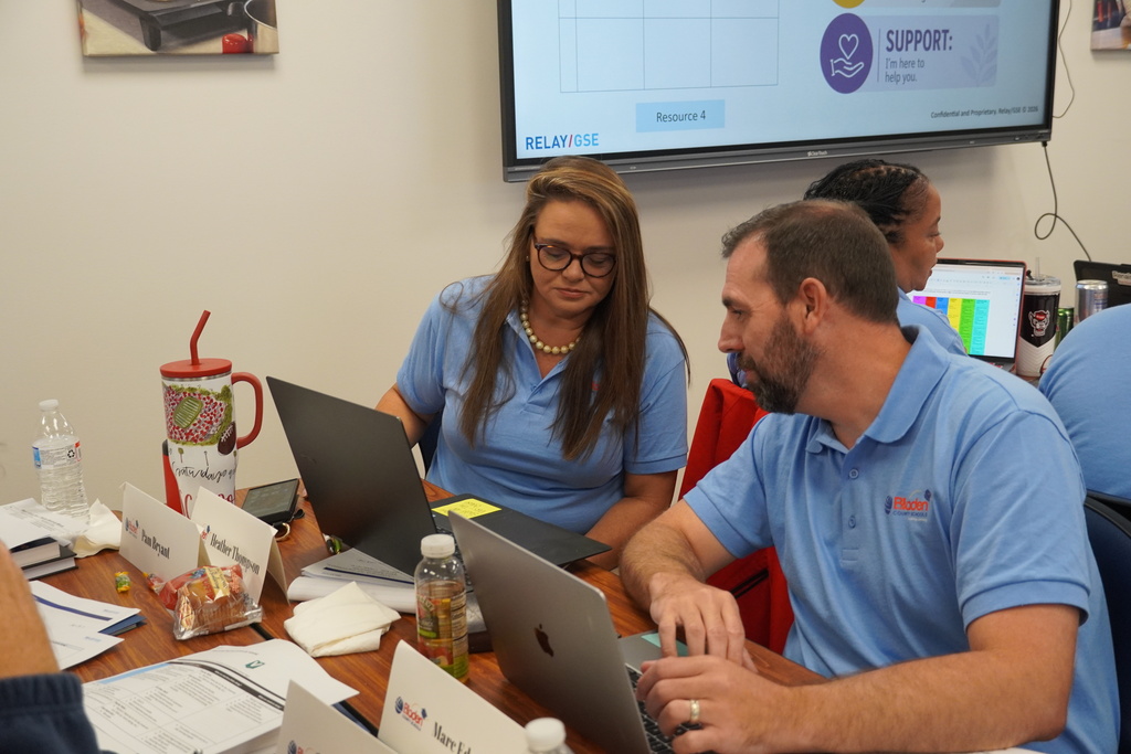 District leaders collaborating together at a desk. 