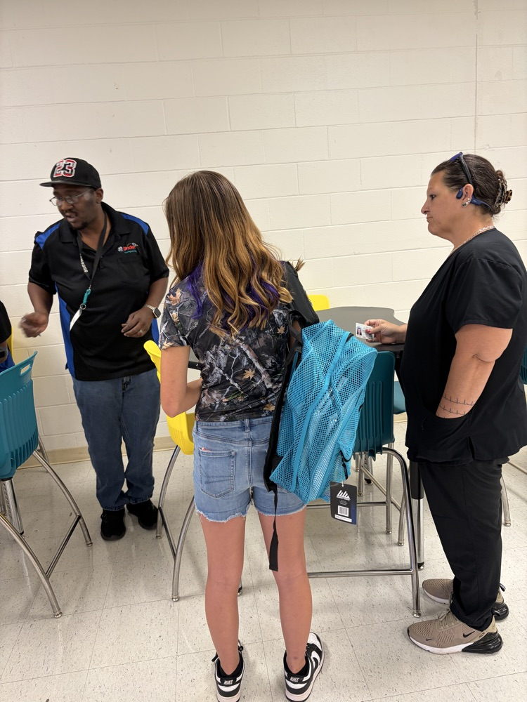 A student and parent wait in line for a Chromebook.