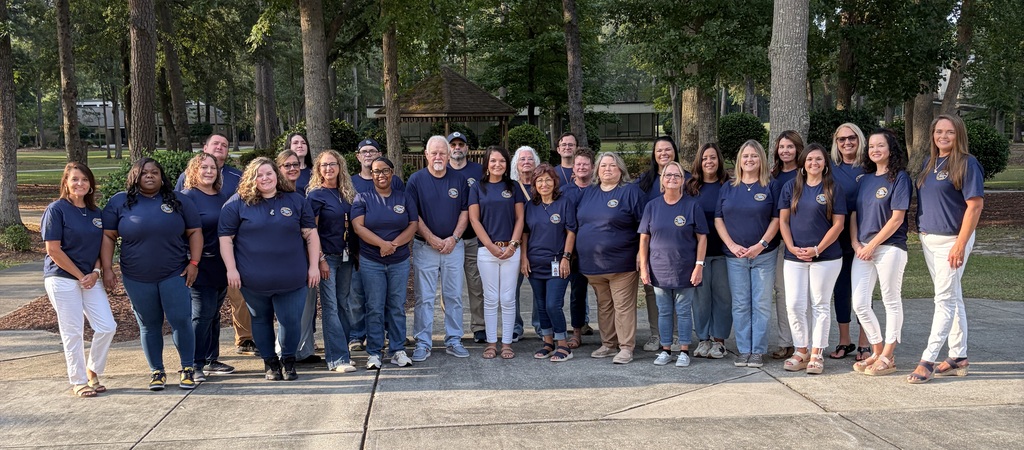 Bladenboro Middle School staff members gather outdoors in matching navy shirts for a group photo. The BMS team stands together smiling, representing unity, Bulldog pride, and excitement for the new school year.