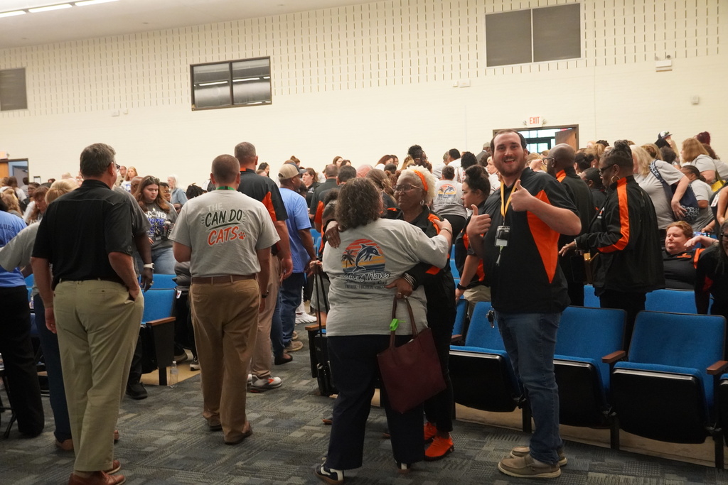 Staff is dispersing and seen hugging and giving thumbs up.