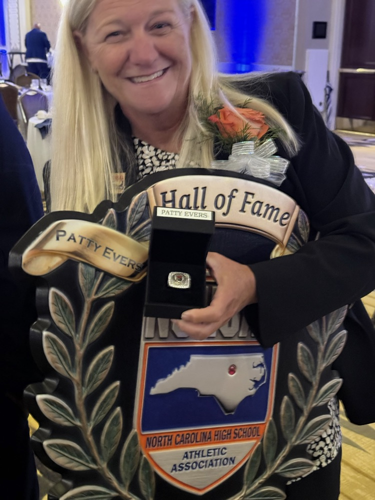 Coach Patty Evers holding an award.