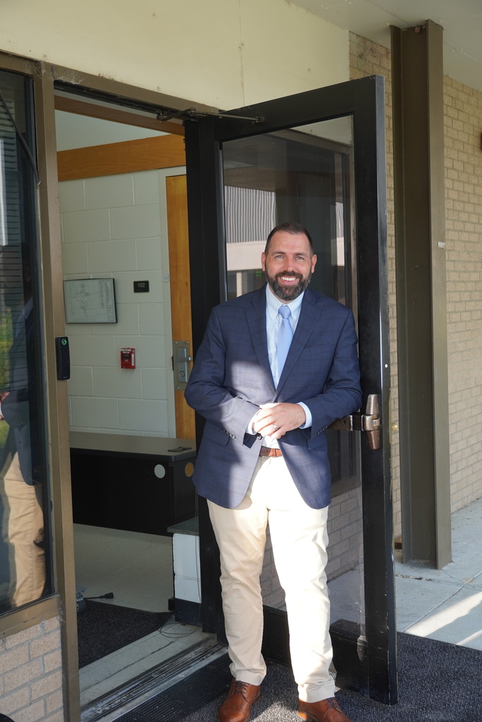 Bladen Early College principal Marc Edge is smiling in the doorway.