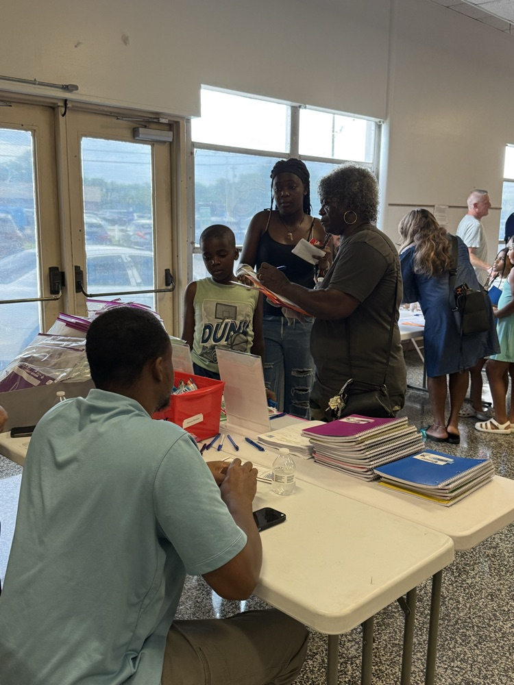     Families visit information tables and talk with staff members inside the cafeteria during Elizabethtown Primary School’s Open House.