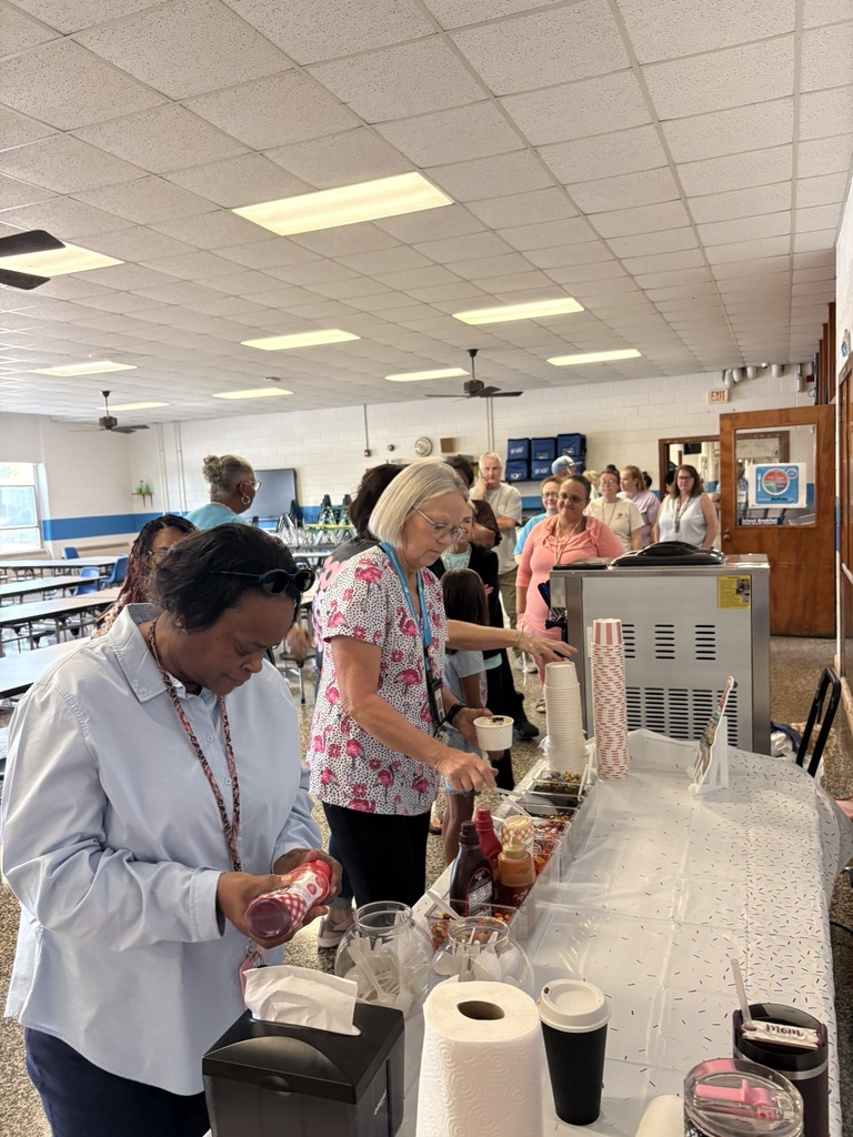 EPS staff members create their own ice cream treats with a variety of toppings and sauces provided by Halo Scoop to celebrate the last workday before students arrive.