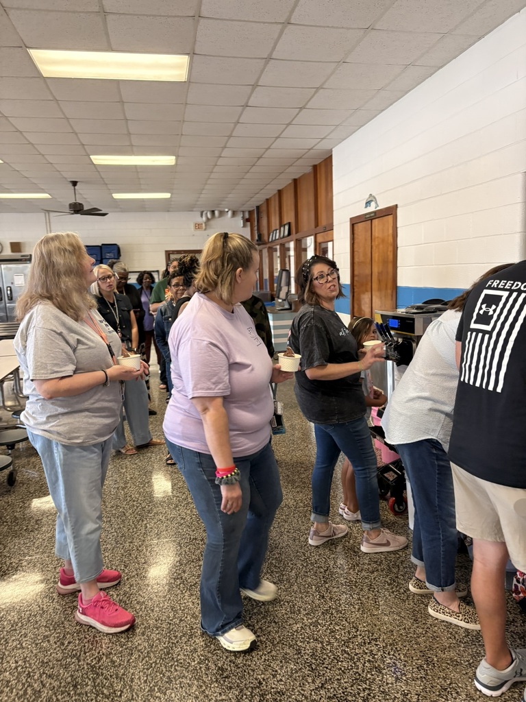 EPS staff wait in line with ice cream cups, enjoying a fun and relaxing treat together as they prepare for the start of the new school year.