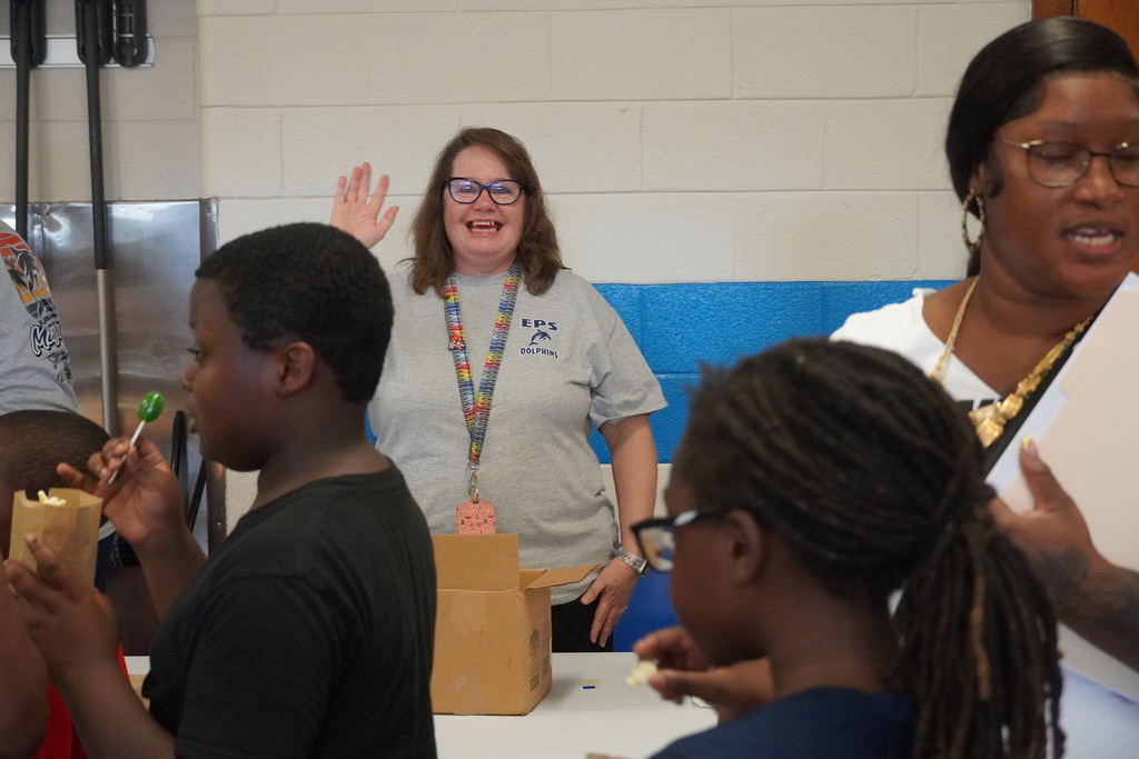 An employee waves at the camera!