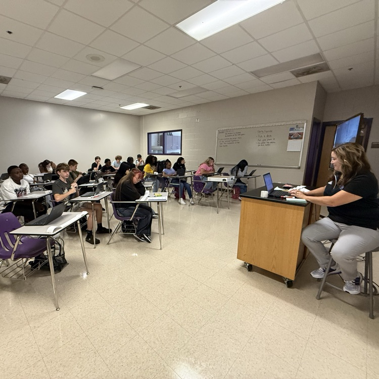 Mrs Rhodes taking attendance while students work silently 