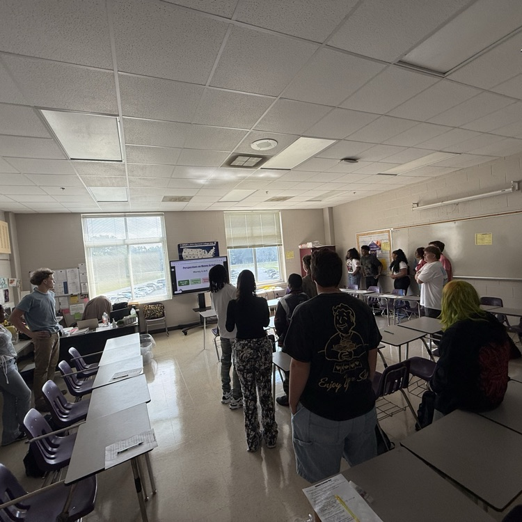 students standing  in a classroom  