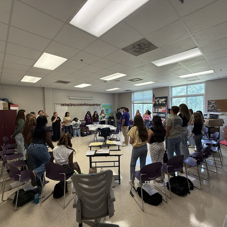 PGC students standing in a circle participating in a group activity 