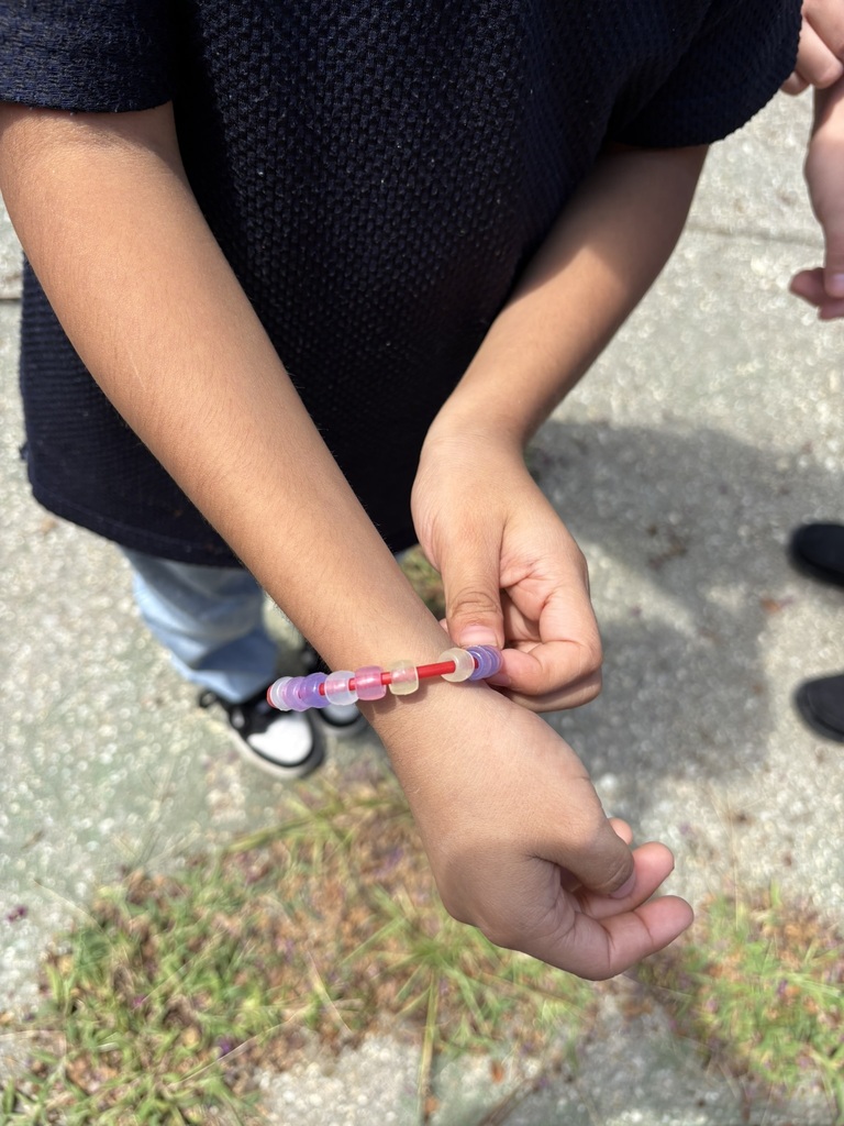 Student wears a bracelet made with color-changing magic beads.