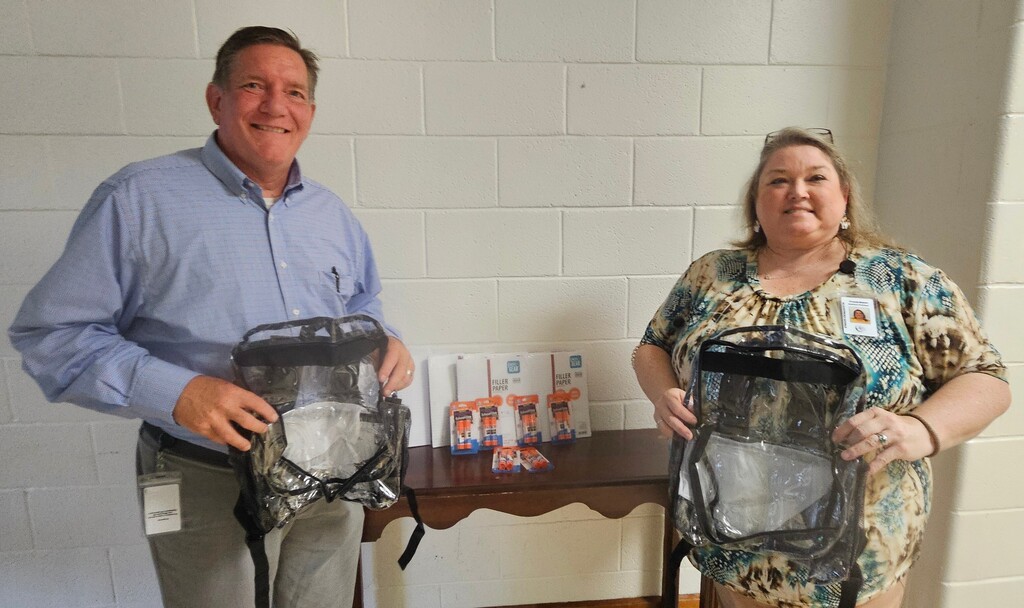 Principal Wimert and AP Bryant holding supplies