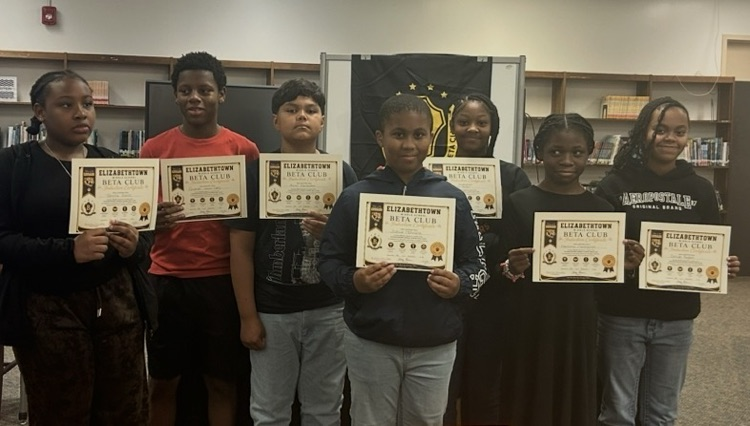 Students holding certificates .
