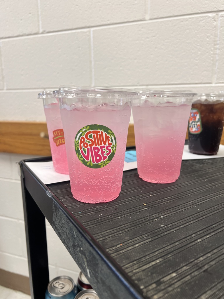 Pink sodas with positive stickers.