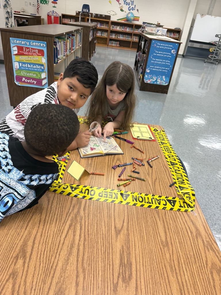 Students examine a marked-up library book for evidence of improper book care.