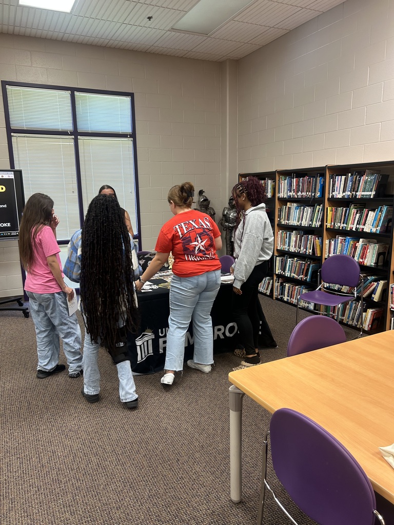 Students gather around a UNC Pembroke admissions table following an information session.