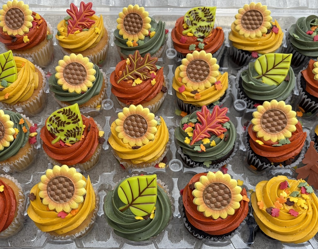 Colorful fall cupcakes topped with sunflowers and leaves