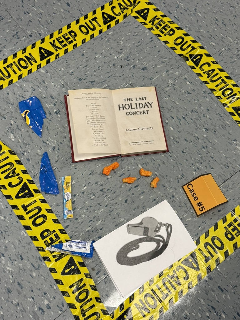 Close-up of a damaged library book surrounded by clues, including a water bottle and glue stick.
