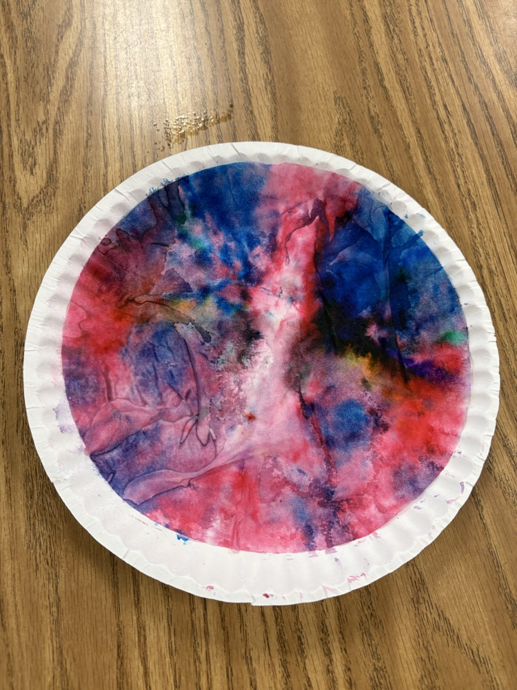 Colorful student-created Dot Day artwork made with blended rainbow colors on paper plates.