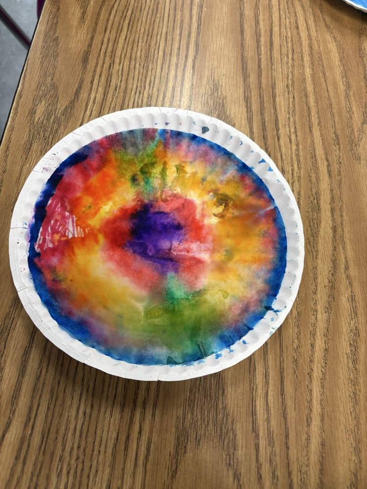 Colorful student-created Dot Day artwork made with blended rainbow colors on paper plates.