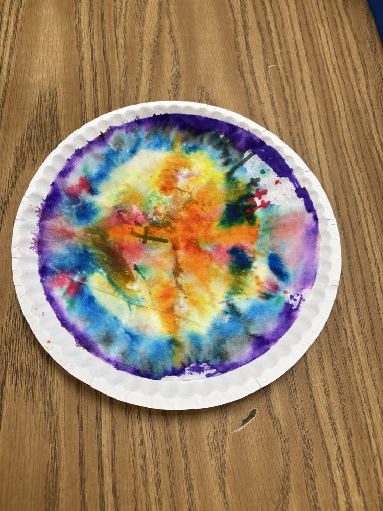 Colorful student-created Dot Day artwork made with blended rainbow colors on paper plates.