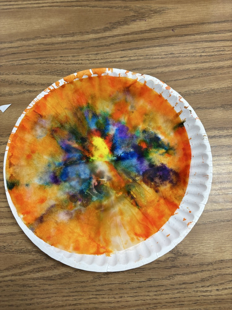 Colorful student-created Dot Day artwork made with blended rainbow colors on paper plates.