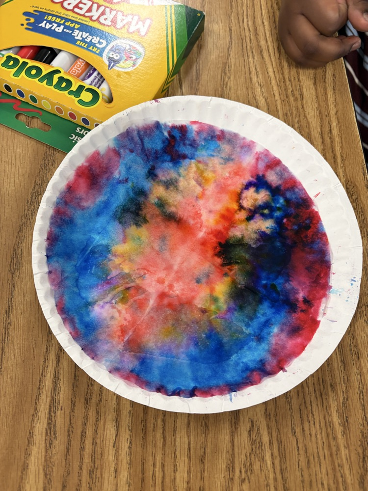 Colorful student-created Dot Day artwork made with blended rainbow colors on paper plates.