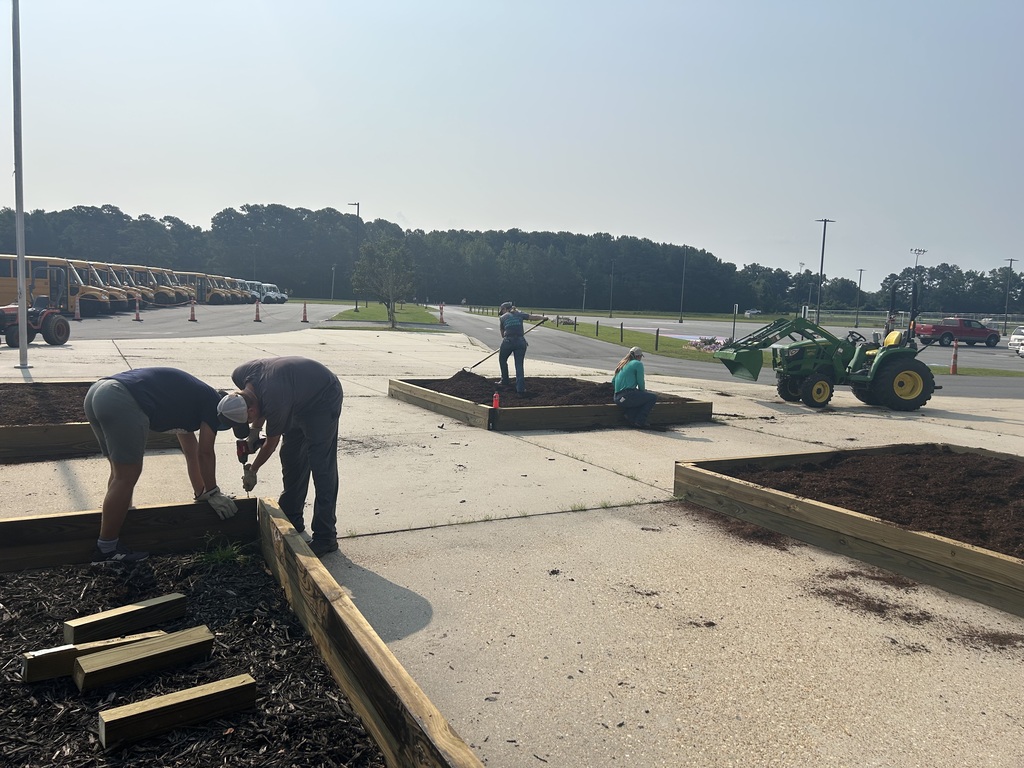 People working on constructing raised garden beds.
