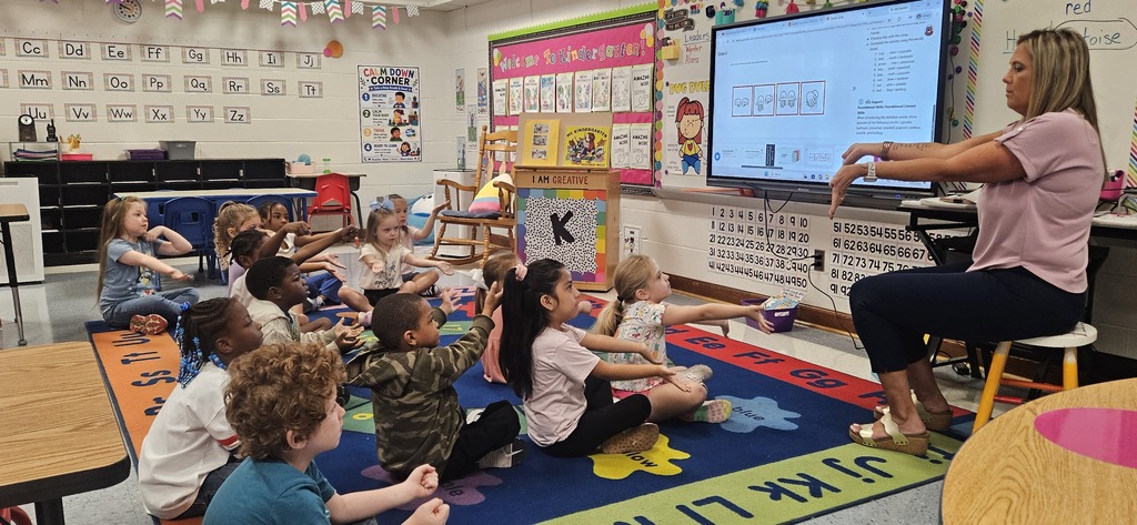 Students doing hand motions for syllables
