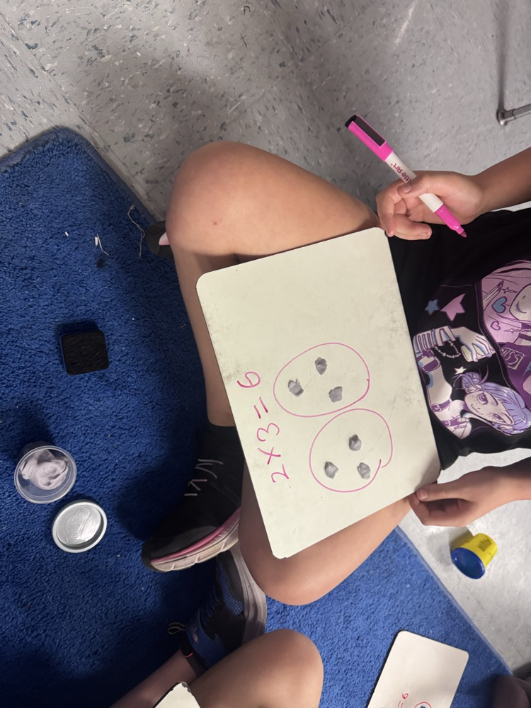 Students use colorful Play-Doh on dry-erase boards to create arrays and equal groups while practicing multiplication facts.