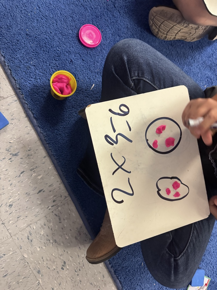 Students use colorful Play-Doh on dry-erase boards to create arrays and equal groups while practicing multiplication facts.